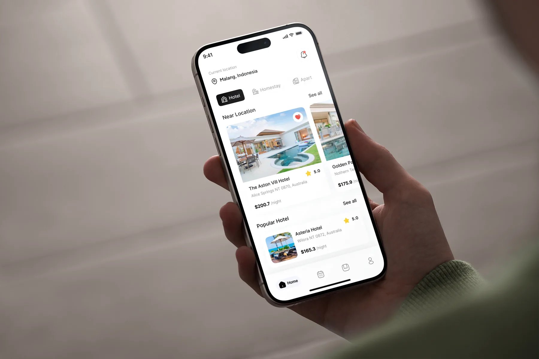 Hotelku home screen on a phone held in hand