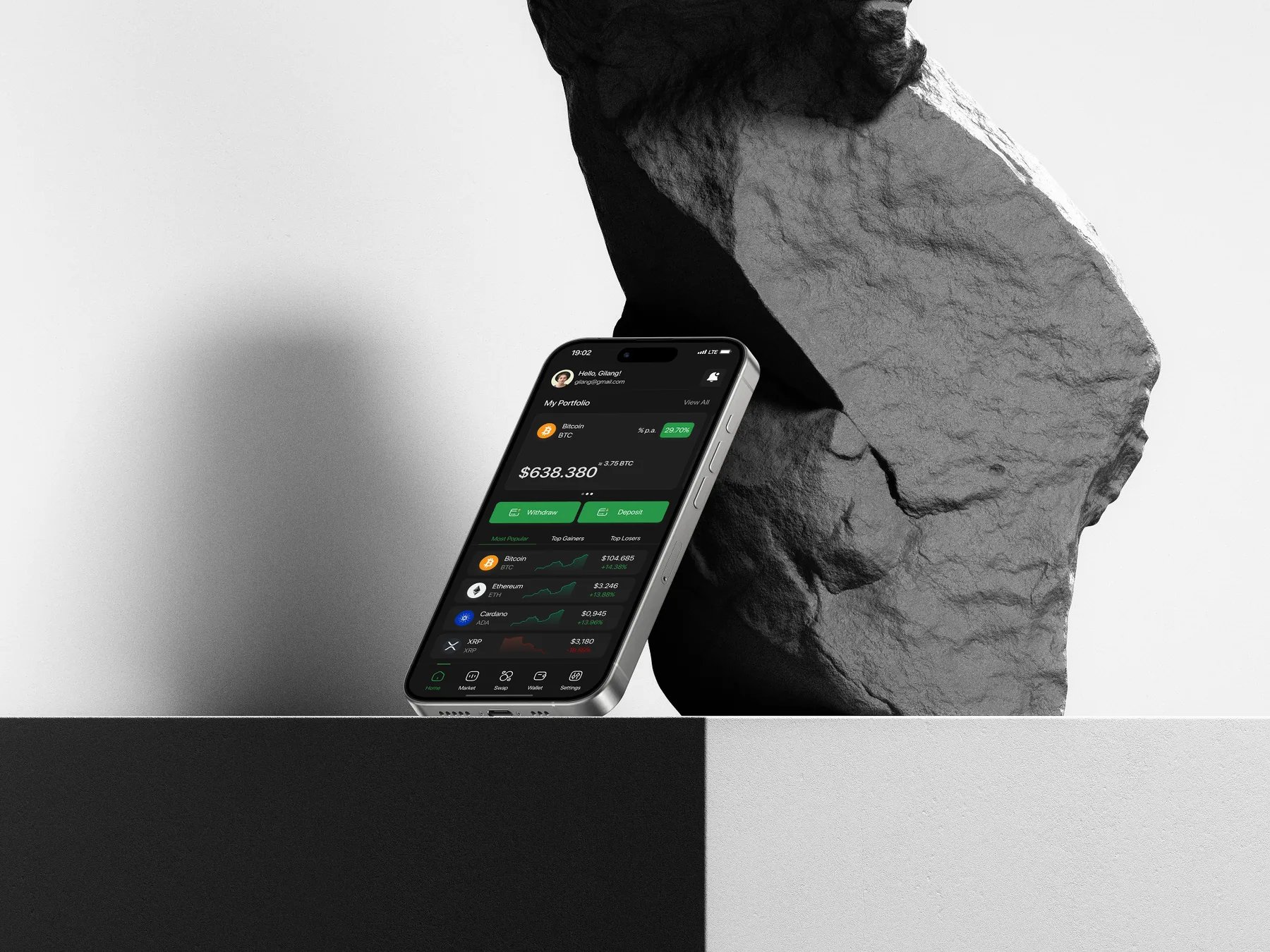 Trado portfolio screen on a phone resting against a stone sculpture